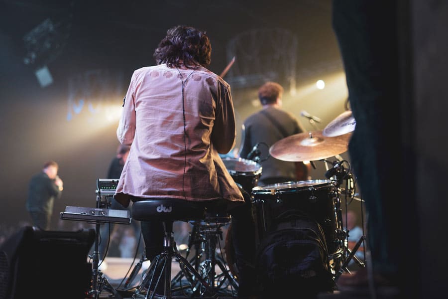 Drummer playing with other musicians on stage