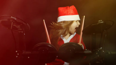 Young Girl Playing Drums in a Santa Costume