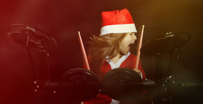 Young Girl Playing Drums in a Santa Costume