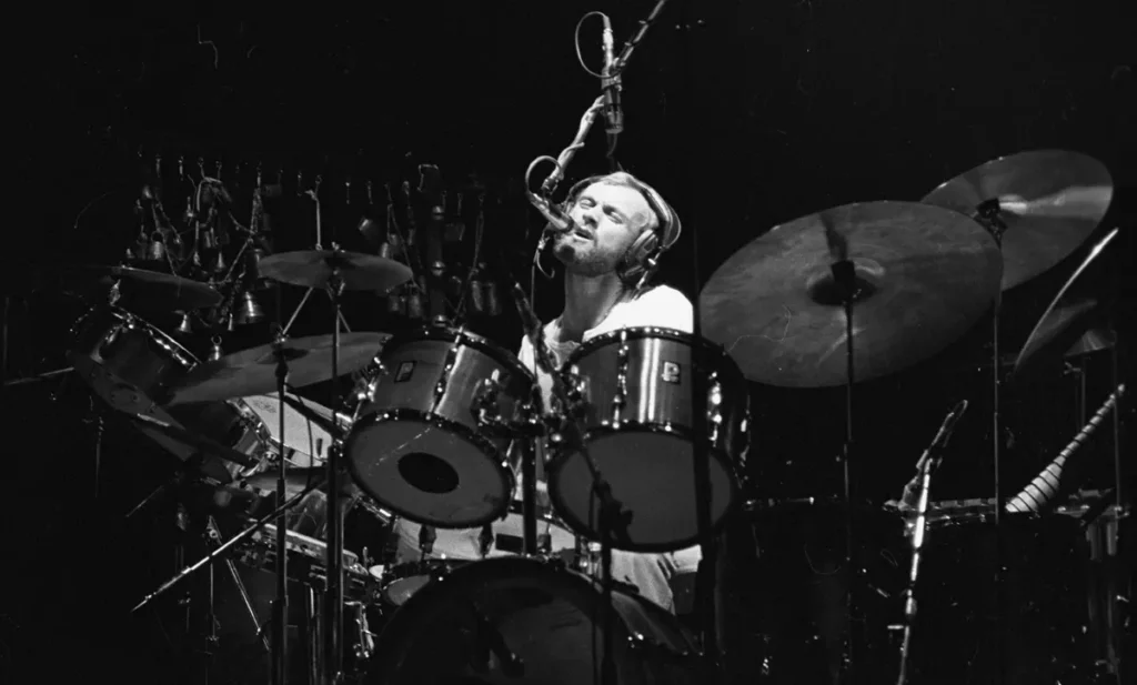 Genesis rock band, performing live on The Lamb Lies Down tour in Manchester, England, in April 28 1975. This remarkable live show was the last to feature singer Peter Gabriel. The photographs show Peter Gabriel in his infamous rubber suit, his leather jacket, as well as guitar player Steve Hackett and drummer Phil Collins. More negatives exist from this set, taken by Simon Robinson.