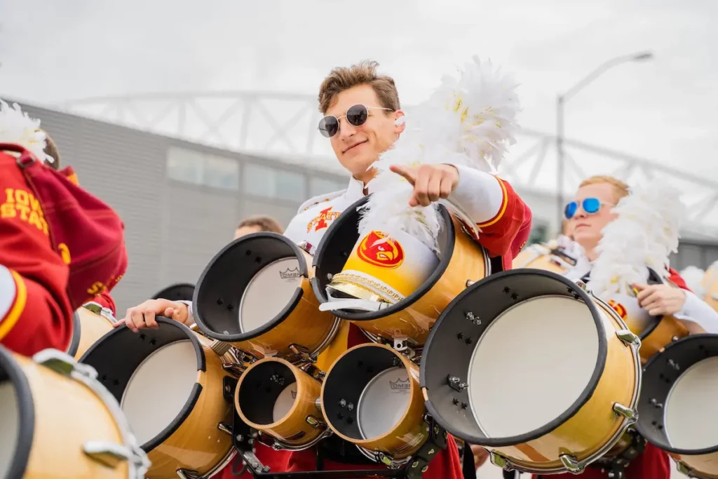 Tenor drummer holding drums while marching