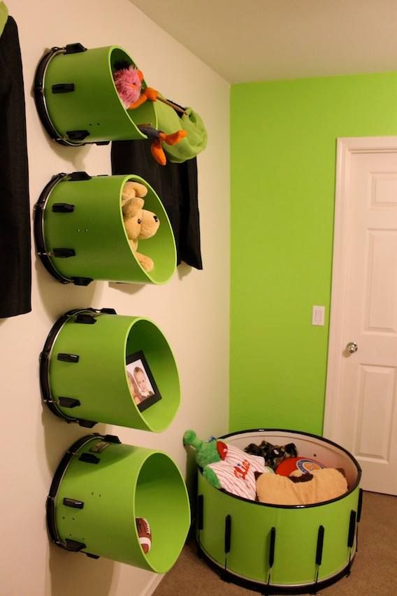 Tom drums mounted on the wall that provide storage for a child's room