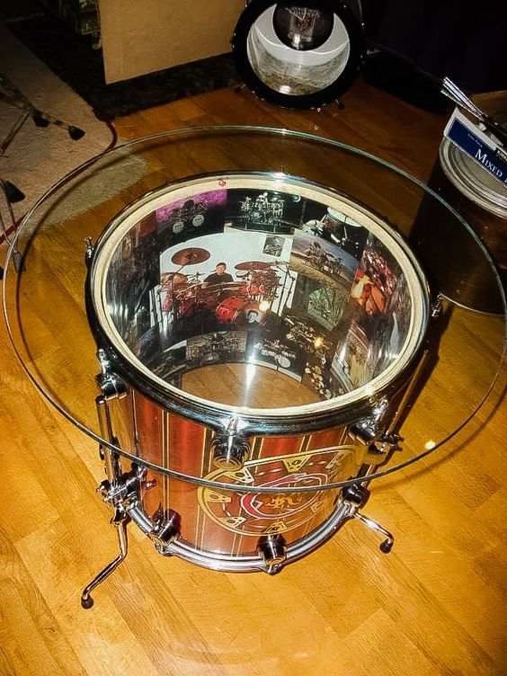 A glass-top coffee table made from a DW floor tom complete with images of Neil Peart on the inside of the shell