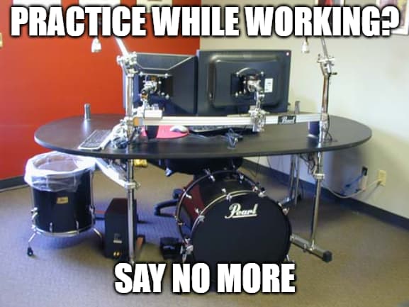 A desk with a bass drum underneath for practicing bass drum patterns and a garbage can repurposed from a floor tom
